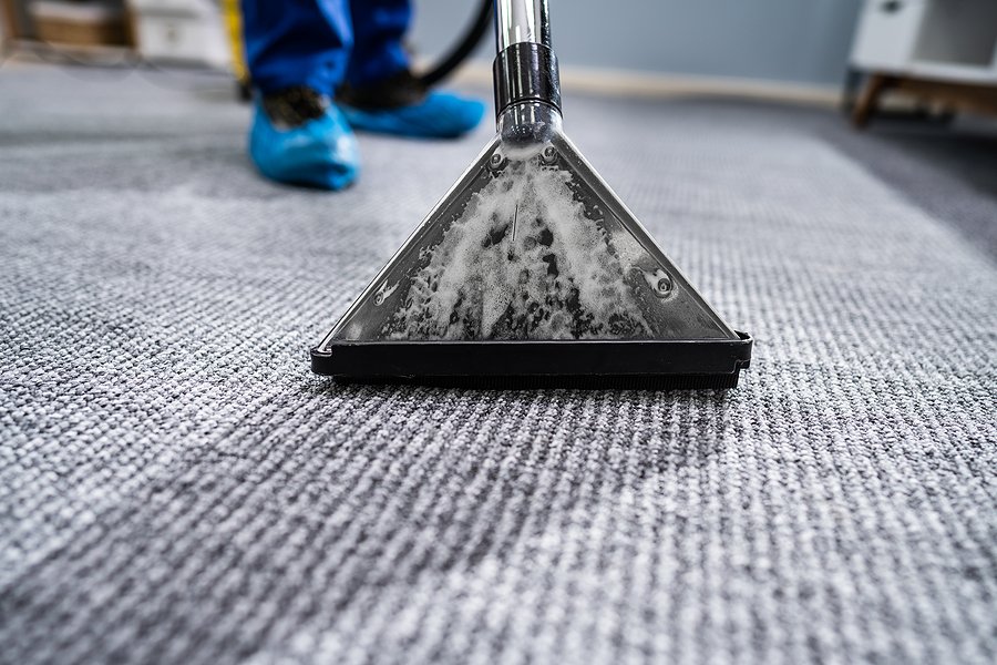 Close-up Of A Cleaning Carpet With Vacuum Cleaner